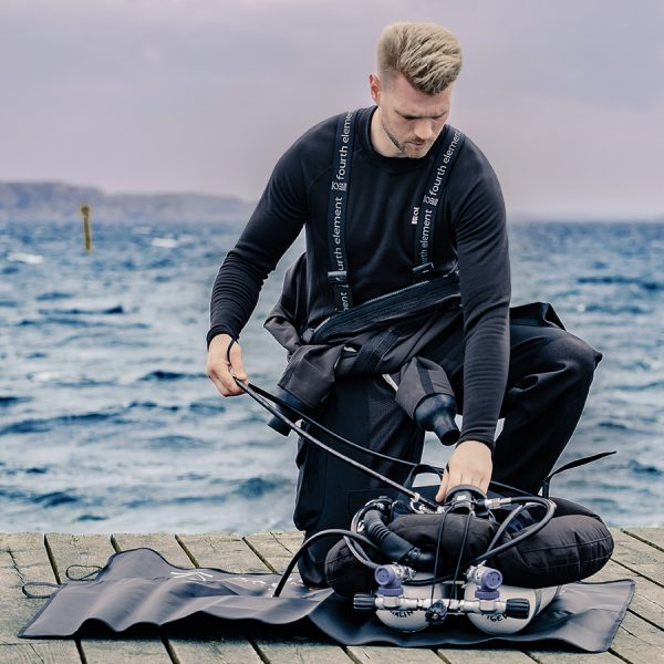 Dive wearing the Fourth Element Xerotherm long sleeve top under their drysuit
