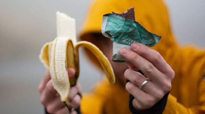 Diver eating a banana and an Outdoor Provisions energy bar for a winter dive