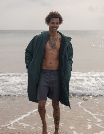 Diver wearing the Fourth Element Tidal Robe next to the shore