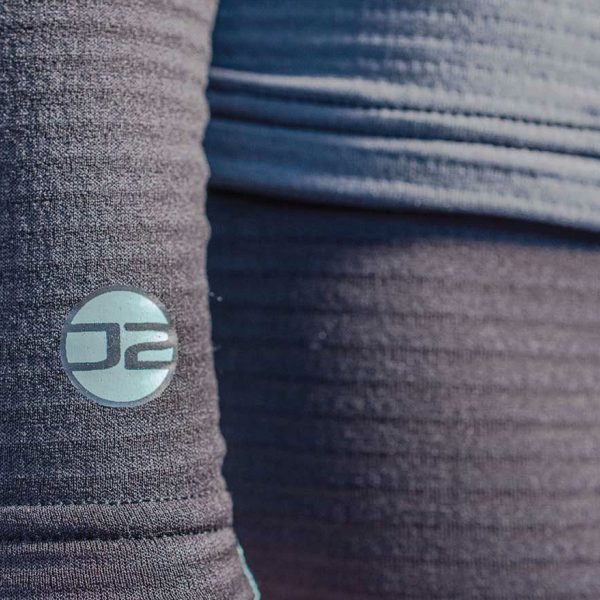 Close up of the logo on the sleeve of the women's Fourth Element J2 Baselayer longsleeve top
