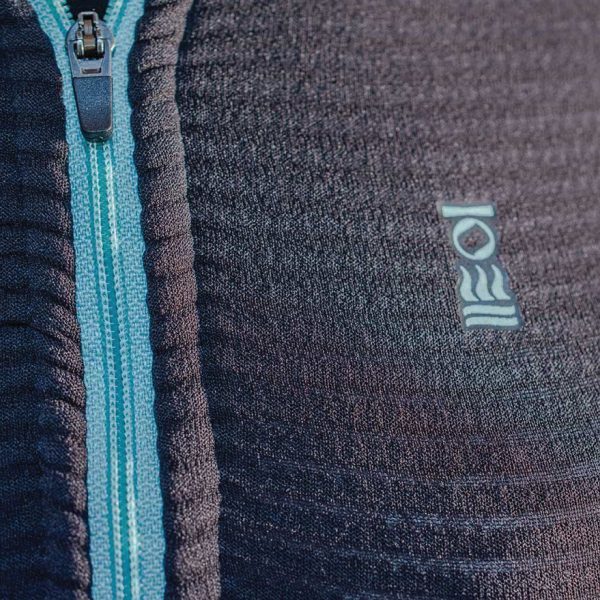 Close up of the logo and zip of the women's Fourth Element J2 Baselayer longsleeve top